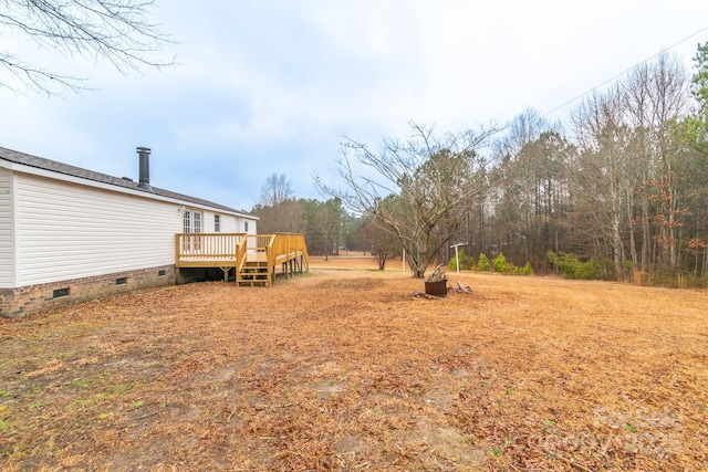 view of yard featuring a wooden deck