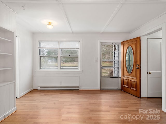 foyer entrance with a baseboard radiator, a wealth of natural light, and light hardwood / wood-style floors