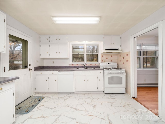 kitchen featuring sink, white appliances, white cabinets, and backsplash