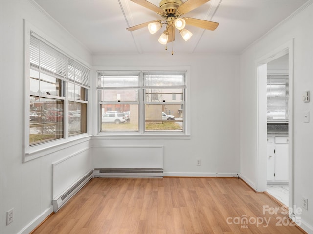 unfurnished room featuring ceiling fan, a baseboard radiator, ornamental molding, and light hardwood / wood-style flooring