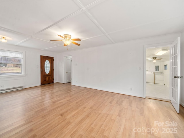 unfurnished living room with ceiling fan, independent washer and dryer, and light hardwood / wood-style flooring