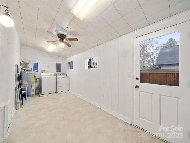 clothes washing area featuring separate washer and dryer, ceiling fan, water heater, and a healthy amount of sunlight