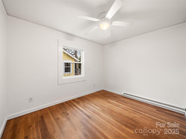 spare room with hardwood / wood-style flooring, ceiling fan, and baseboard heating