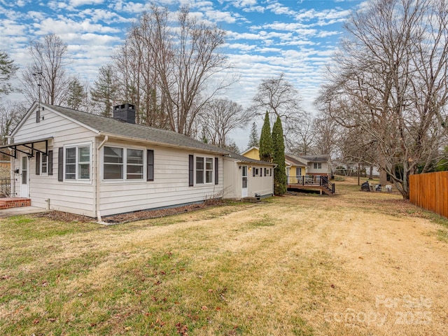 exterior space with a deck and a lawn