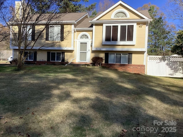 bi-level home with a front lawn