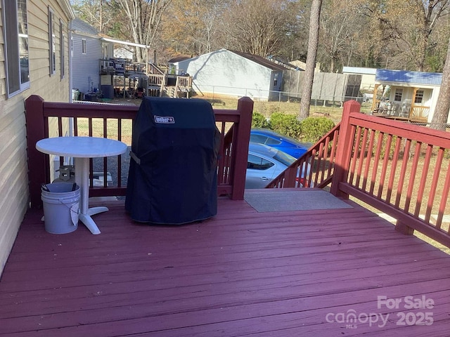 wooden deck featuring a grill