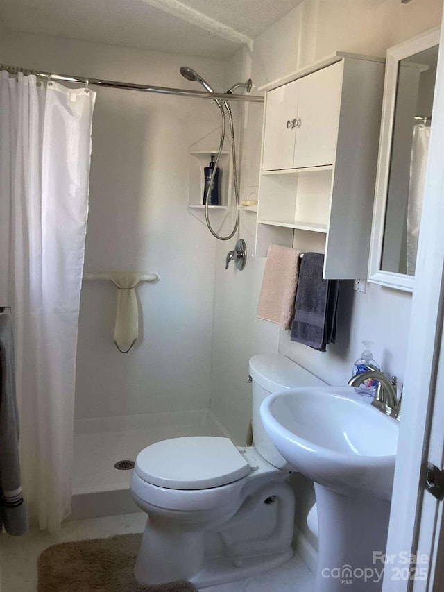 bathroom with a shower with curtain and toilet