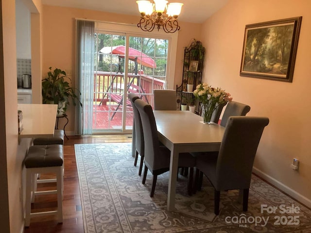 dining room with wood-type flooring and a chandelier