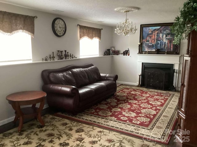 living room featuring an inviting chandelier, a wealth of natural light, and a textured ceiling