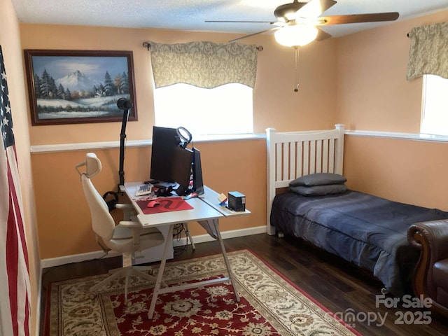 bedroom featuring dark hardwood / wood-style floors and multiple windows