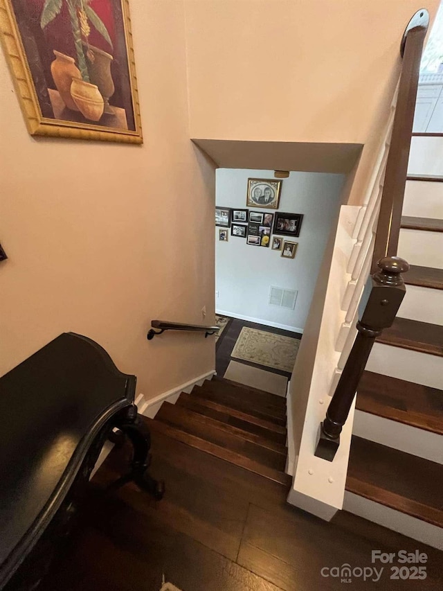 staircase with wood-type flooring