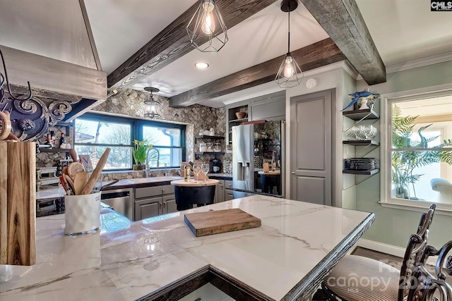 kitchen with light stone counters, appliances with stainless steel finishes, gray cabinets, beam ceiling, and open shelves