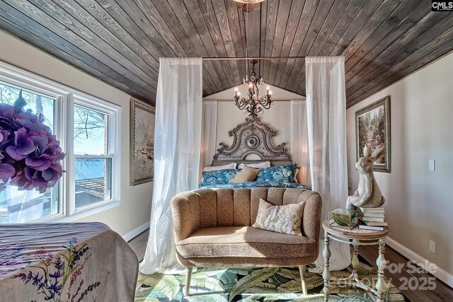 bedroom with baseboards, lofted ceiling, wooden ceiling, wood finished floors, and a notable chandelier