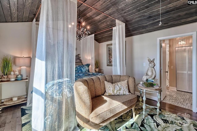 living area with wood ceiling, baseboards, and wood finished floors