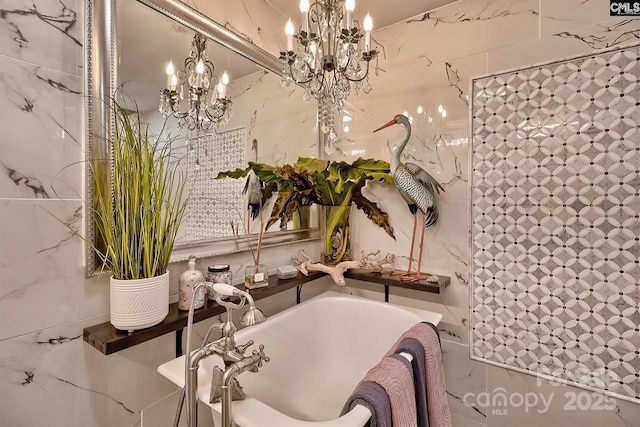 full bath with a bathing tub, tile walls, and a notable chandelier