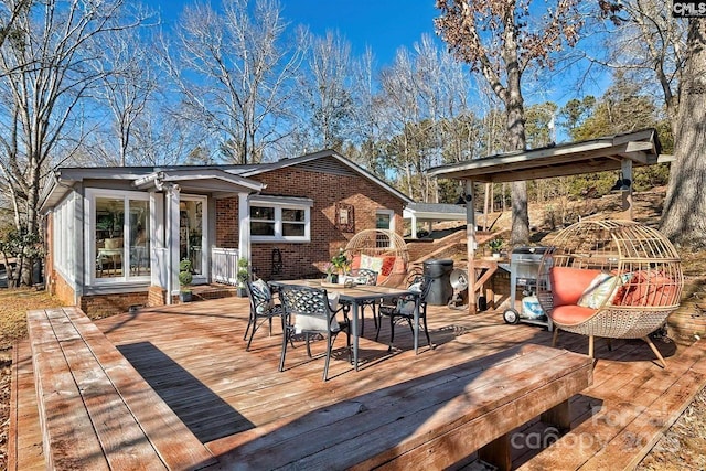 wooden terrace with outdoor dining space