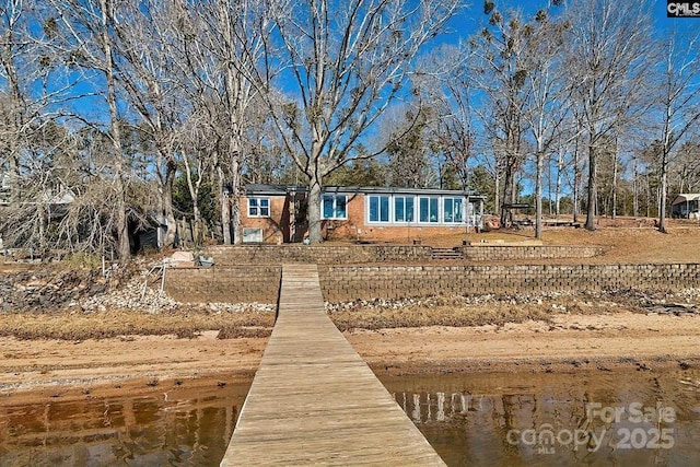 rear view of property with a water view