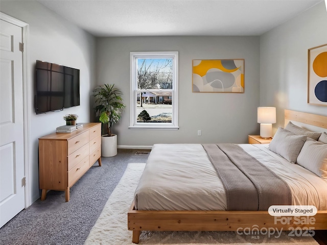 bedroom featuring dark carpet