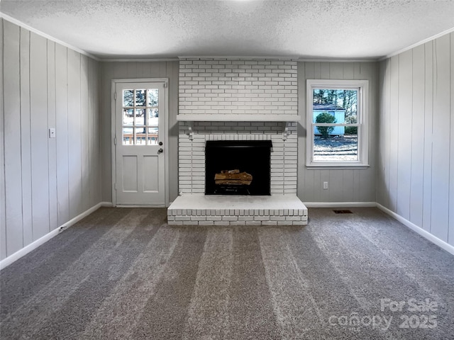 unfurnished living room with carpet, a wealth of natural light, and a brick fireplace