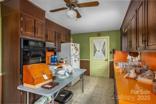 kitchen featuring white refrigerator, oven, and ceiling fan