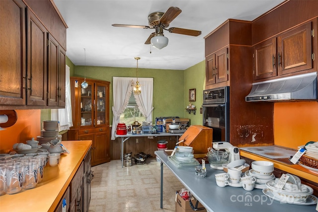 kitchen with pendant lighting, ceiling fan, oven, and stovetop