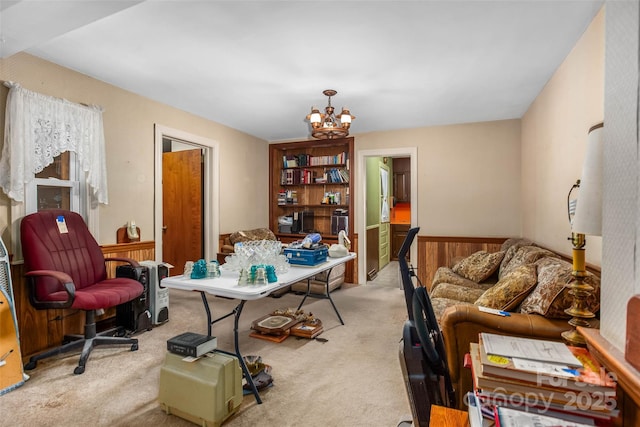 home office featuring light colored carpet, a chandelier, and wood walls