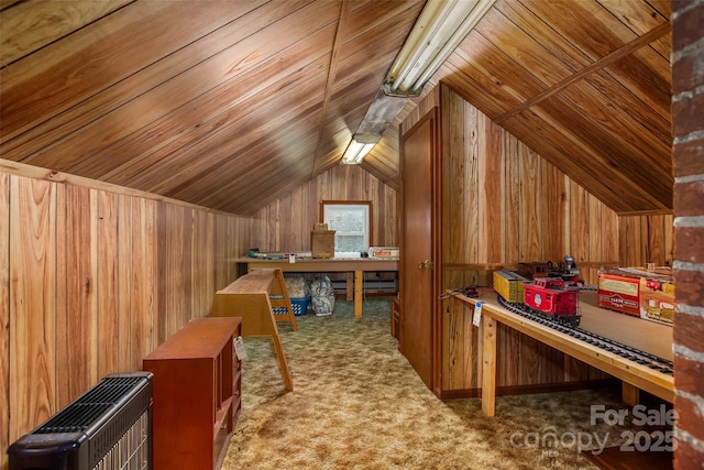 bonus room featuring heating unit, wooden walls, vaulted ceiling, and carpet