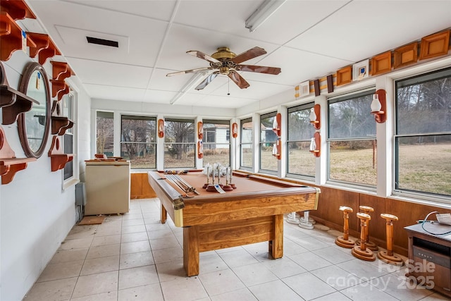 recreation room with light tile patterned flooring, a paneled ceiling, wood walls, billiards, and ceiling fan