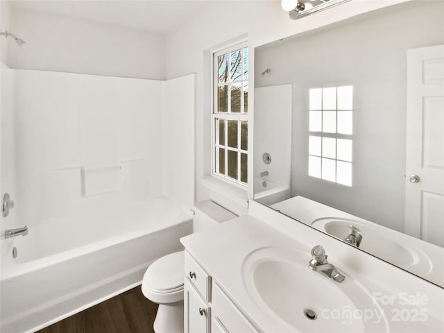 full bathroom with hardwood / wood-style flooring, shower / tub combination, vanity, and toilet