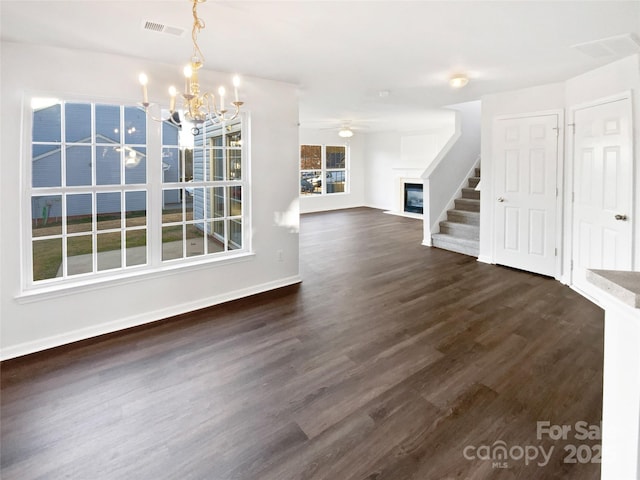 unfurnished dining area featuring dark wood-type flooring and a chandelier