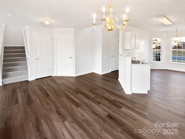 kitchen featuring a notable chandelier, sink, and dark hardwood / wood-style floors