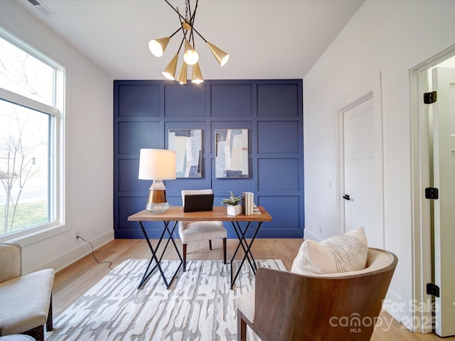 office featuring a notable chandelier and light wood-type flooring