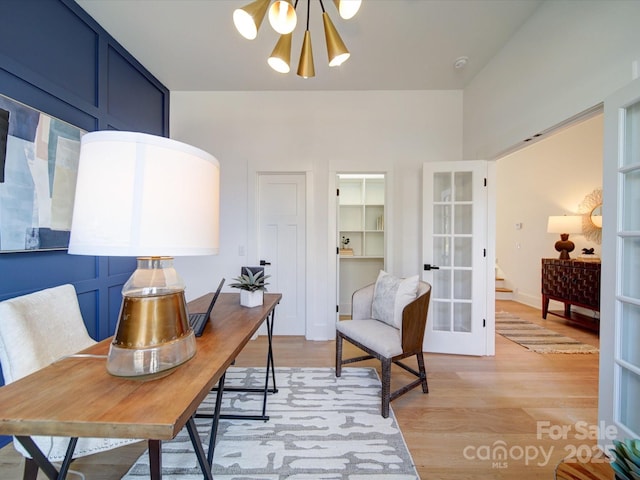 office featuring an inviting chandelier, light hardwood / wood-style flooring, and french doors