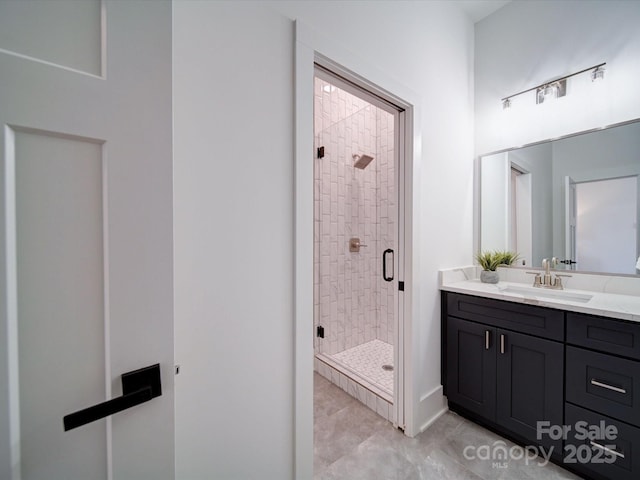 bathroom with a shower with door and vanity