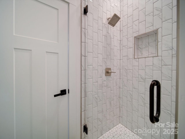 bathroom with a tile shower