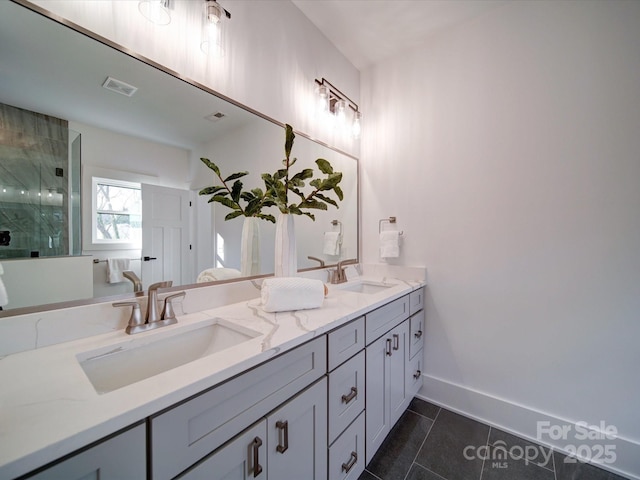 bathroom with tile patterned floors, vanity, and an enclosed shower