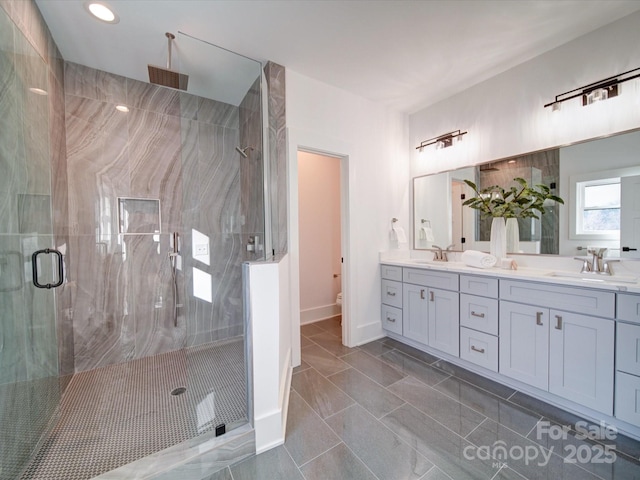 bathroom with vanity, tile patterned floors, and a shower with door