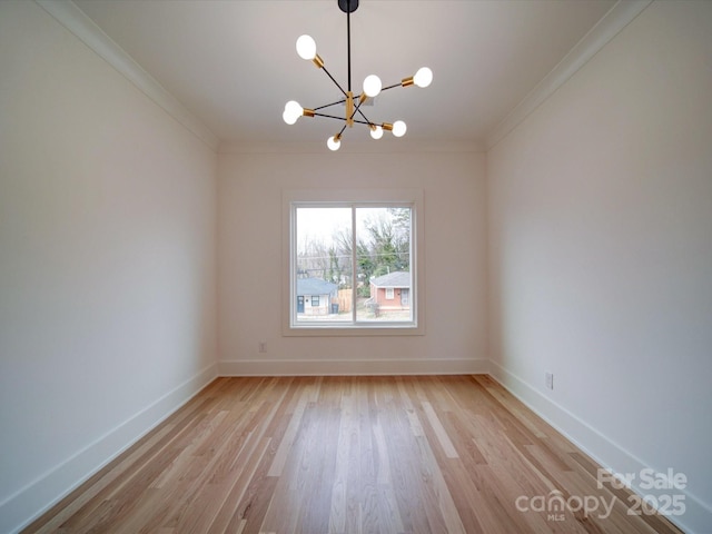 empty room with an inviting chandelier, crown molding, and light hardwood / wood-style floors