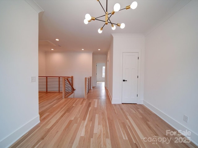 interior space featuring ornamental molding and light wood-type flooring