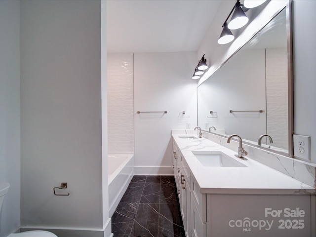 bathroom featuring vanity and toilet