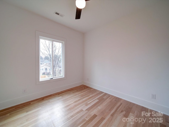 spare room featuring ceiling fan and light hardwood / wood-style flooring