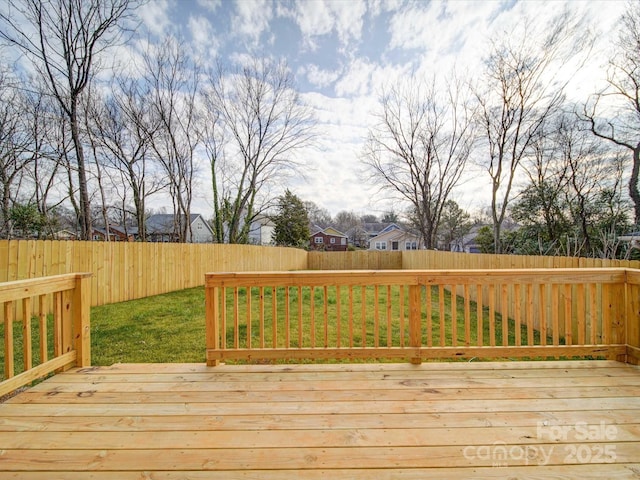 wooden terrace featuring a lawn