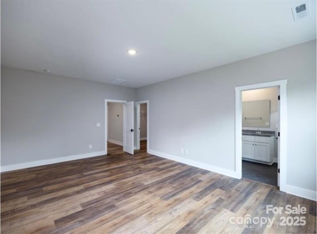114 Glencoe Ln Unit 106, Mooresville, NC 28117 - unfurnished bedroom with wood finished floors, ensuite bath, and recessed lighting