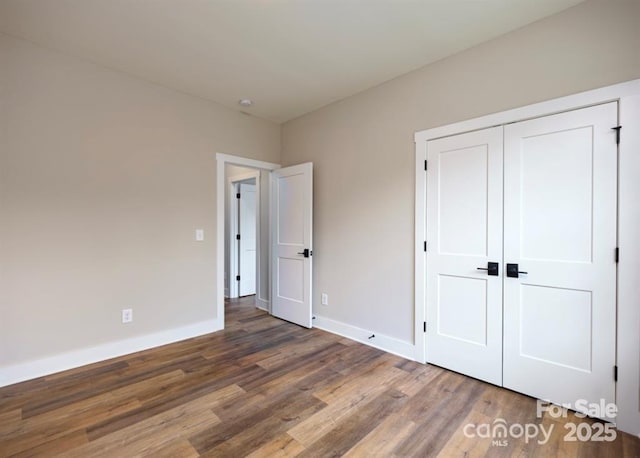 114 Glencoe Ln Unit 106, Mooresville, NC 28117 - unfurnished bedroom featuring wood finished floors and a closet