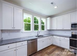 114 Glencoe Ln Unit 106, Mooresville, NC 28117 - kitchen featuring stainless steel appliances, dark wood-style floors, and white cabinetry