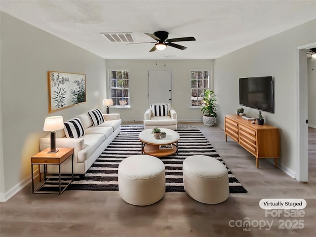 living room featuring hardwood / wood-style floors and ceiling fan