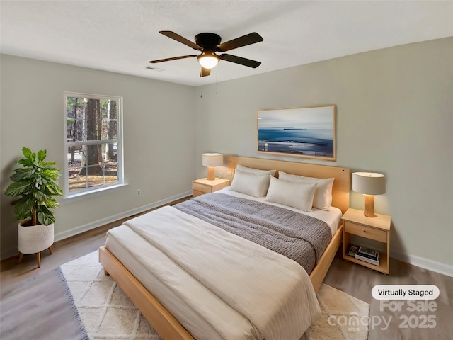 bedroom with ceiling fan and light wood-type flooring