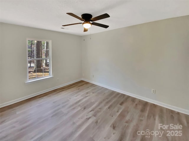 empty room featuring a textured ceiling, light hardwood / wood-style floors, and ceiling fan