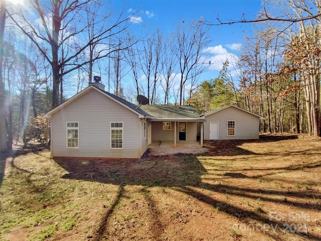 back of house featuring a yard and a patio