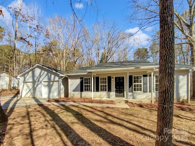 ranch-style home with a porch and a garage